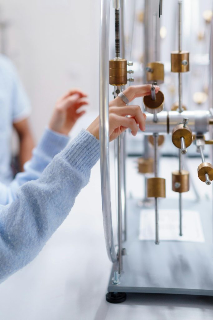 pexels photo 6208694 6208694 Focused shot of a person interacting with an experimental device in a laboratory setting.